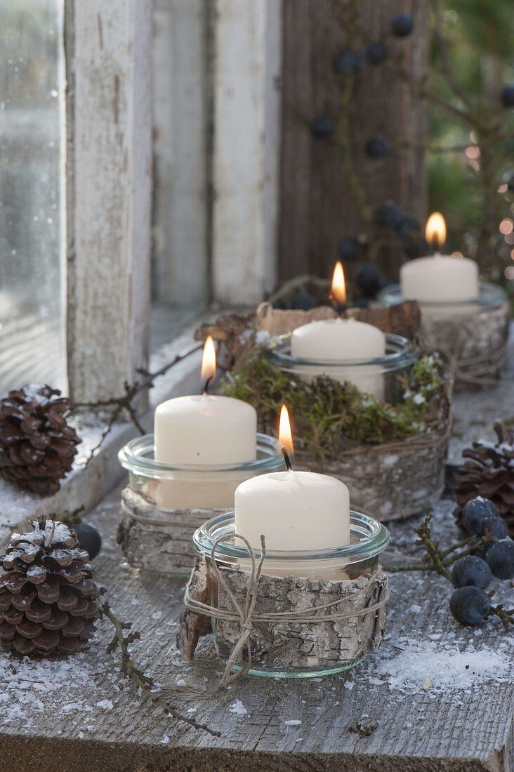 Preserving jars as lanterns with birch bark, cones, sloes