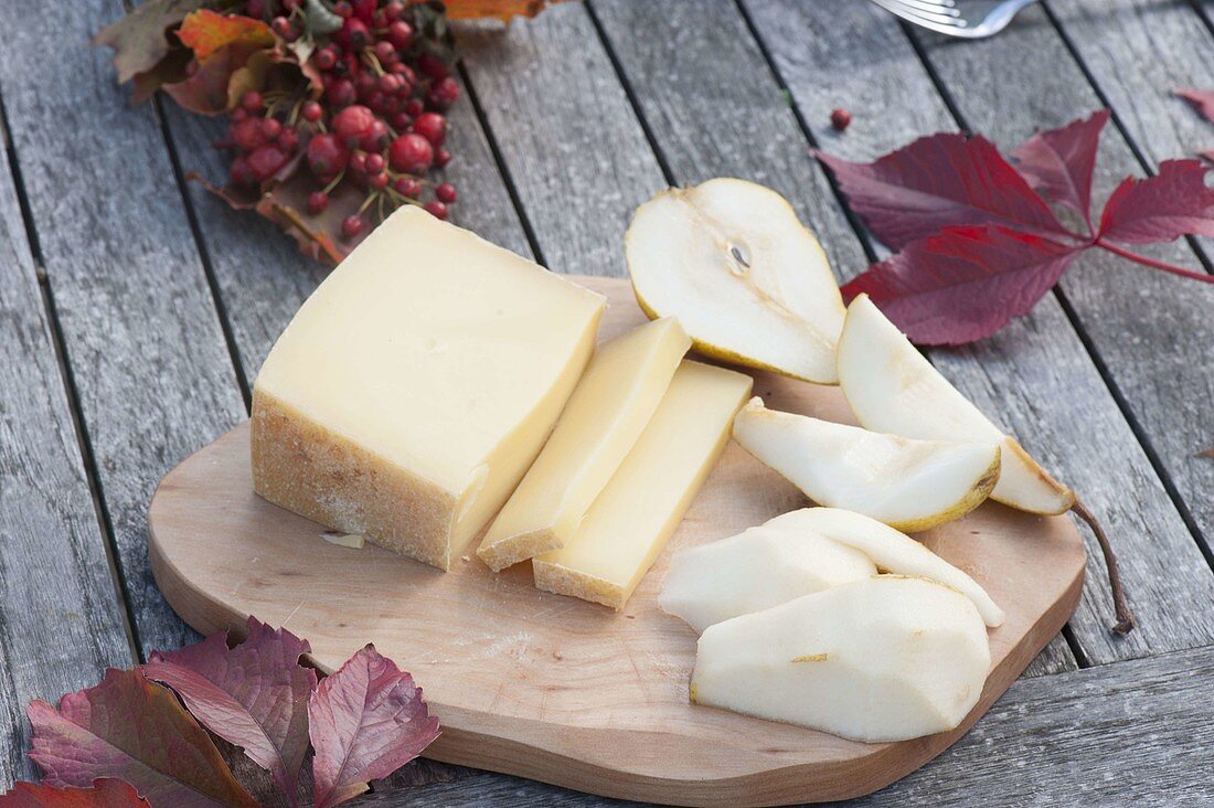 Wooden board with pears and cheese
