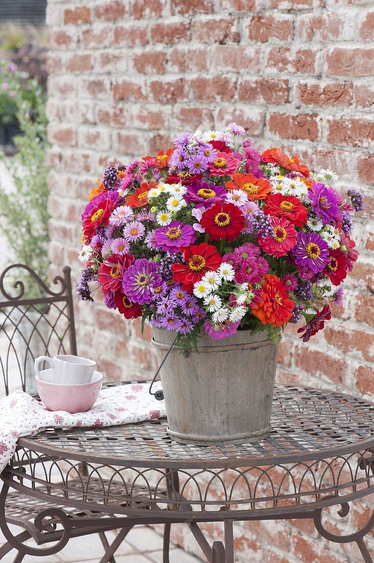 Rustic bouquet made of zinnia, aster (white wood aster)