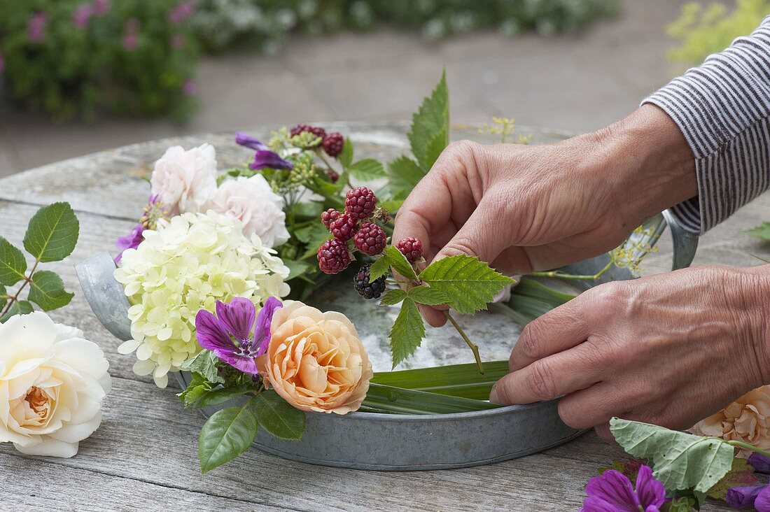 Flower wreath with candles on zinc tray