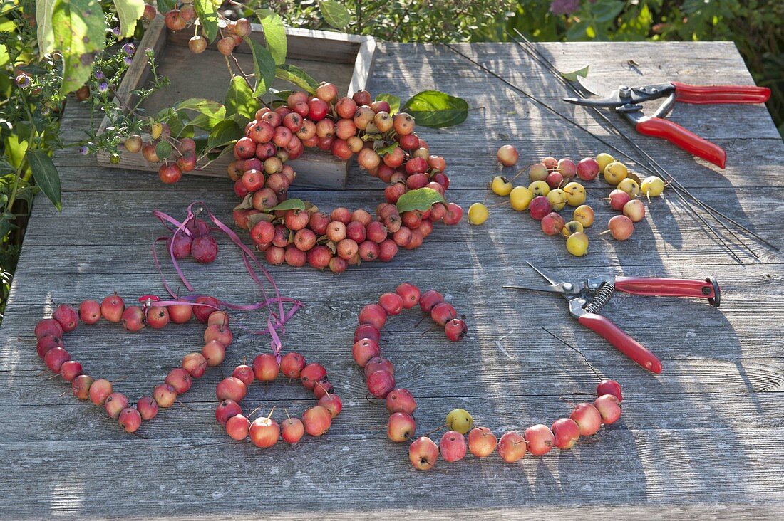 Wooden table as a workplace for crafting with ornamental apples