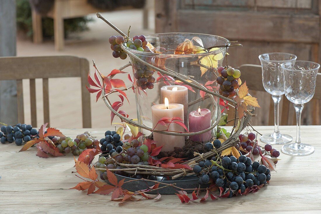 Large glass with candles as a lantern, decorated with grapes