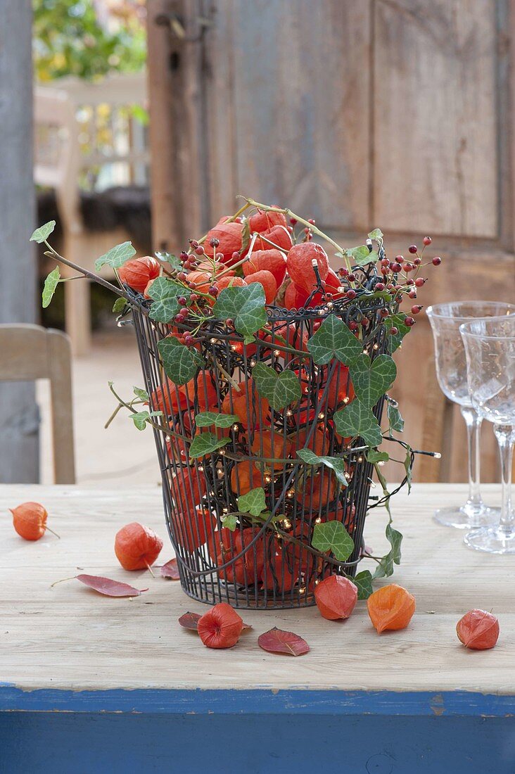 Basket with physalis, hedera tendrils, Rosa multiflora