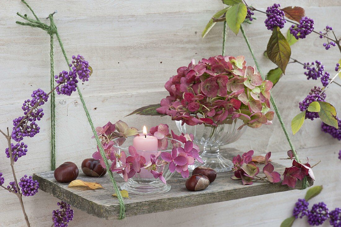 Simple board hung as shelf on the wall, glass bowls with flowers