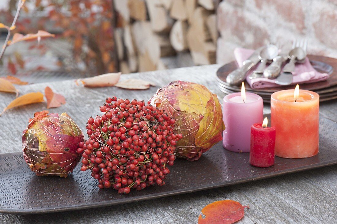 Autumn balls tied from colorful leaves and pinks