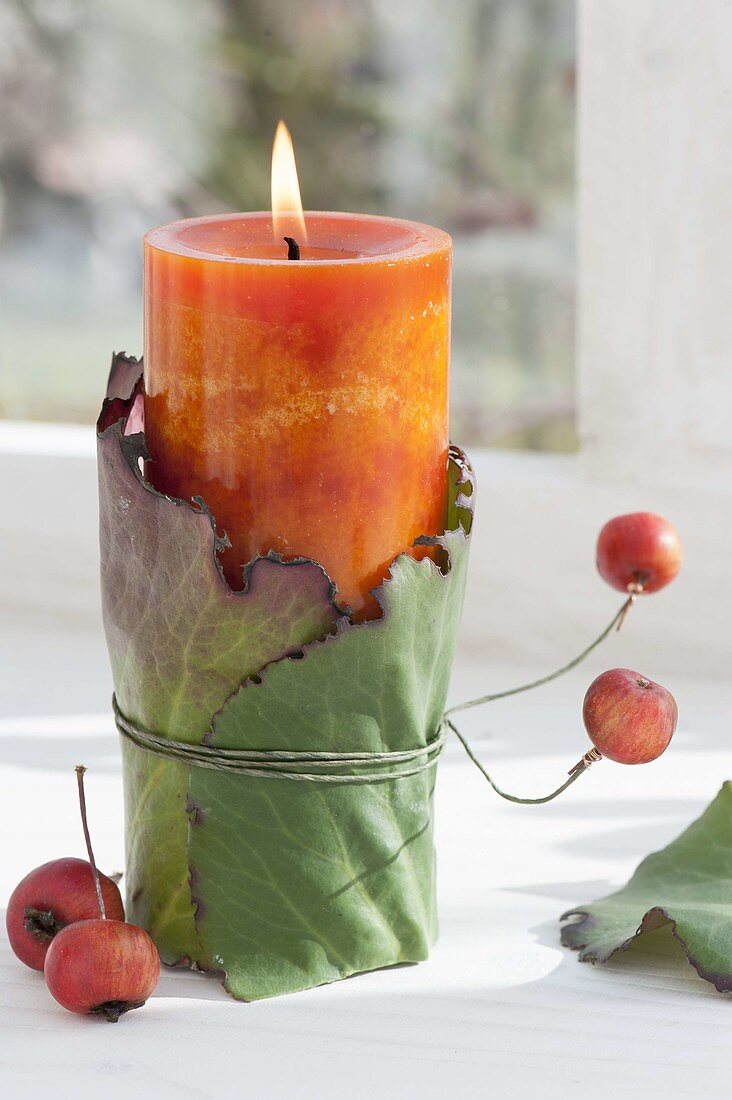 Natural candle deco on the window