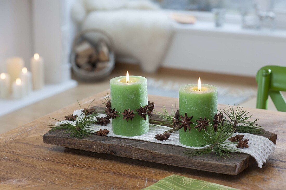 Small Advent decoration, green candles with garlands of star anise