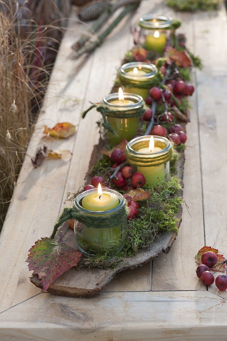 Autumn table decoration with mason jars as lantern flowers