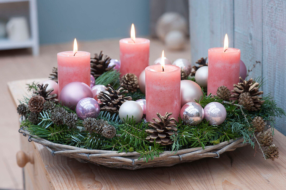 Advent wreath in basket bowl with Christmas baubles, Abies branches