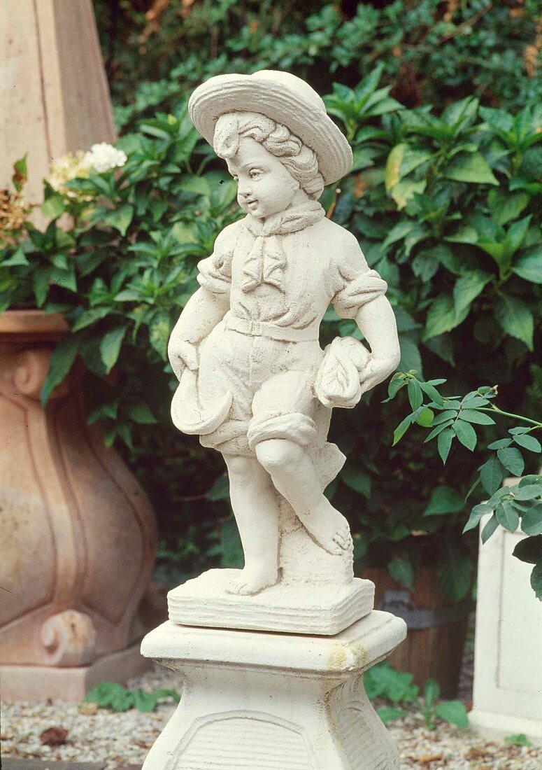 Putto on pedestal: boy in short trousers with hat