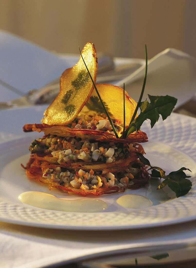 Potato rosti layered into a tower with vegetables tartar