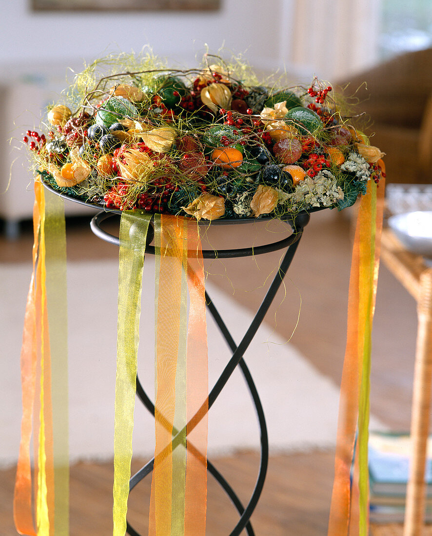 Wreath with sugared fruits: Limes, physalis, grapes, kumquat.
