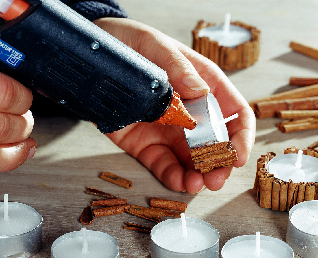 Decorate tea lights: Stick cinnamon sticks with hot glue