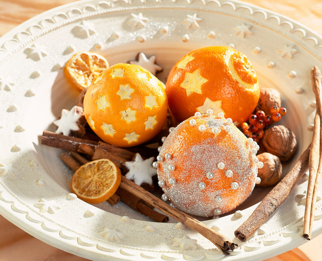 Oranges decorated for Christmas with pearl pins.