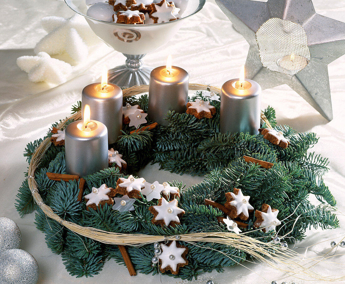 Advent wreath with fir branches, cinnamon sticks, cinnamon stars