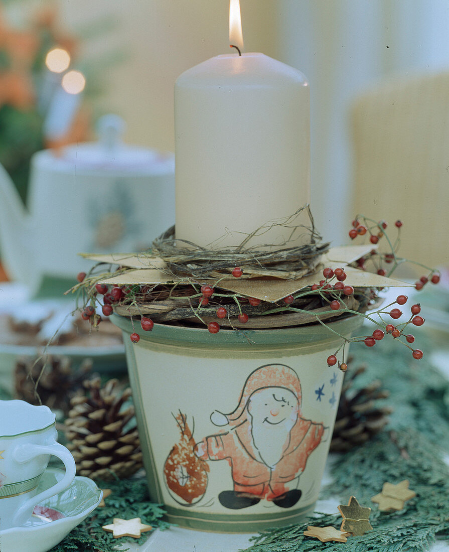 Christmas pot with twigs, stars and candle