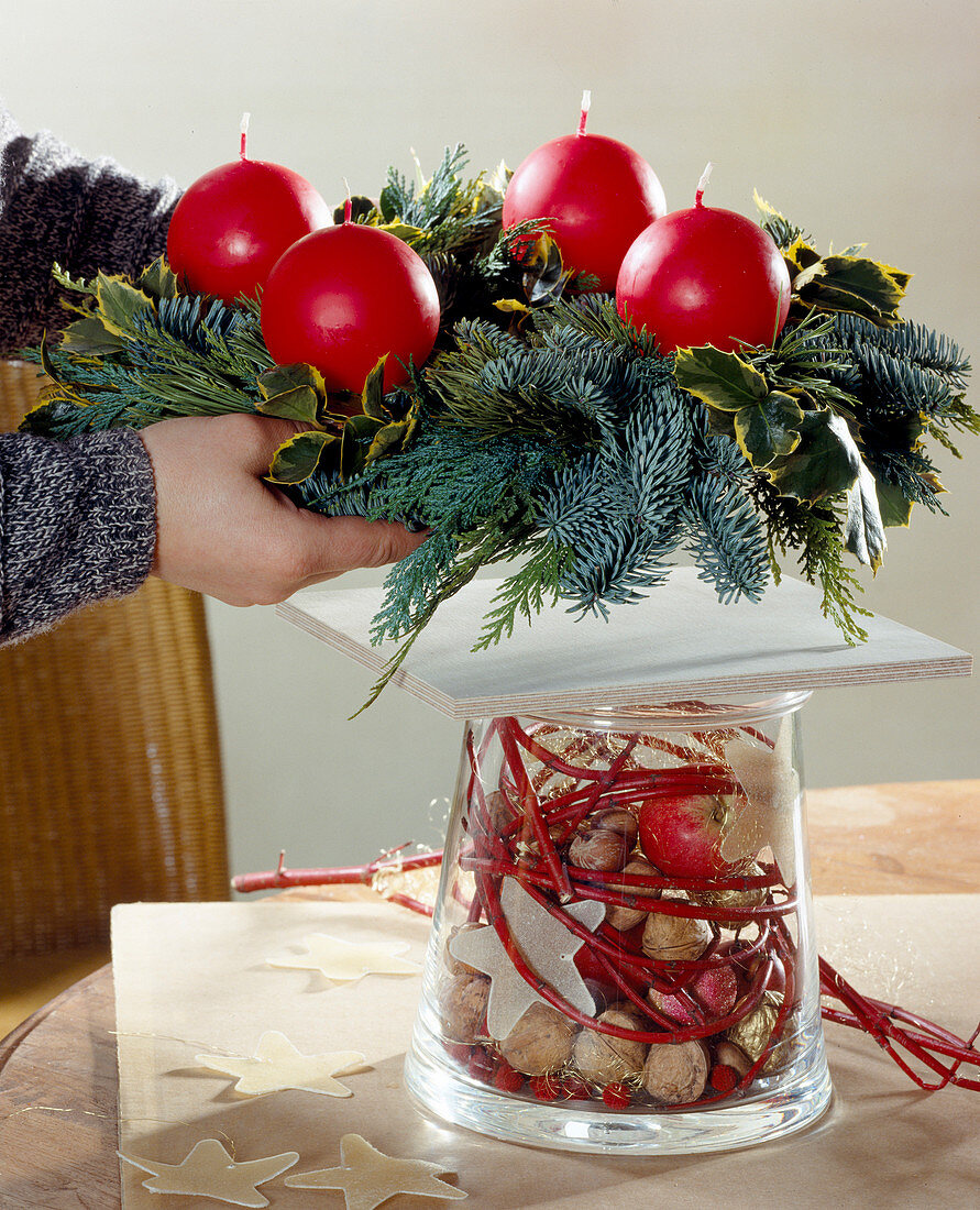 Advent wreath on decorated glass, wreath on wooden board