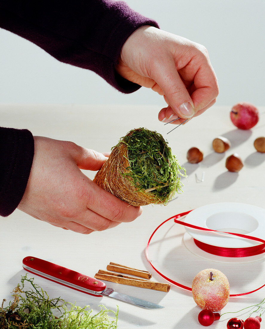 Homemade tree ornaments. Fixing moss with bent wire