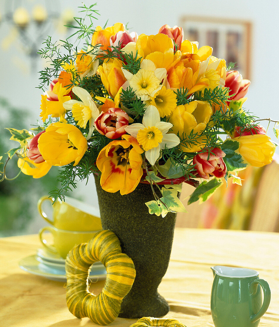 Bouquet of tulips, daffodils, ivy leaves and ornamental asparagus branches