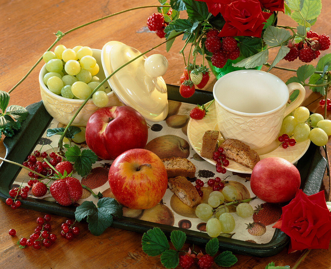 Style with apples, peach, grapes, strawberries, currants and rose petals