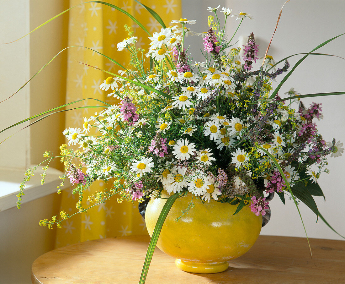 Meadow flower bouquet of daisies, camomile, yellow bedstraw, civet and grasses