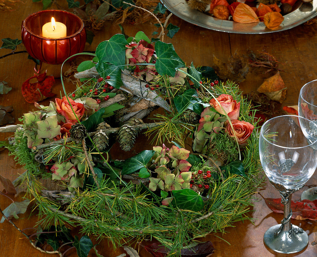 Autumn wreath made of driftwood, larch twigs tied to a wreath with wire, hydrangea