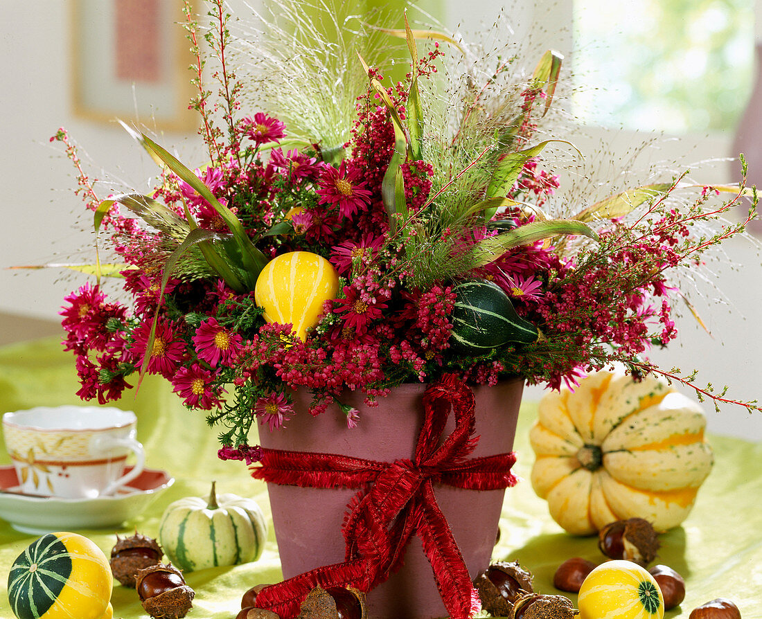 Autumn bouquet with Erica gracilis (heather), Aster (autumn asters), grasses, ornamental gourd