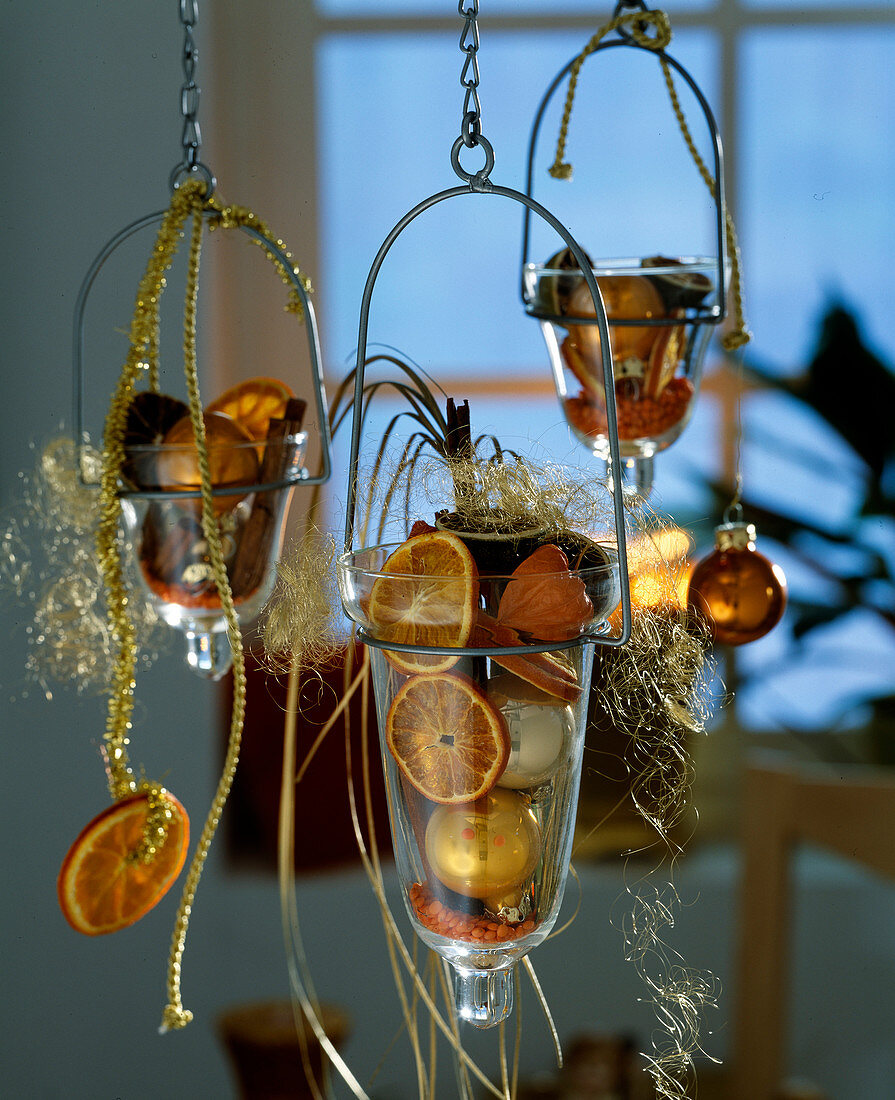 Hanging glasses filled with adventitious flowers