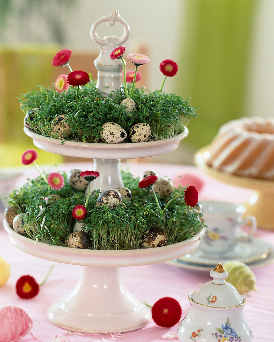 Easter table decoration, cake stand made of porcelain with cut-out cress