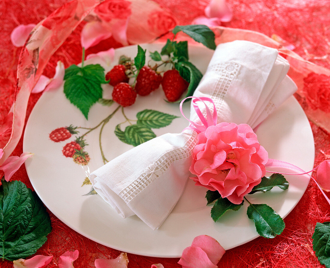 Plate decoration: rose petals and raspberries
