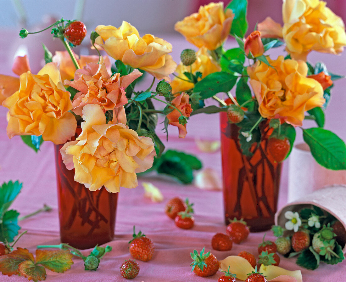 Rosa 'Tequila' (roses), Fragaria (strawberries), red glass vases