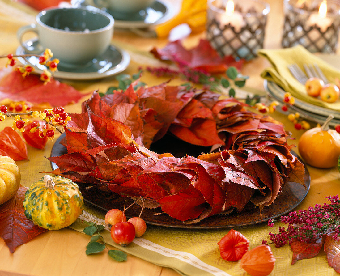Plate wreath from leaves of scarlet cherry, gourds, crab apples, lanterns as decoration
