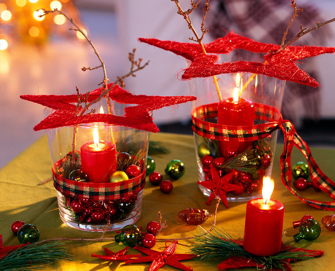 Lanterns with red sisal stars, Pinus (pine needle), Forsythia