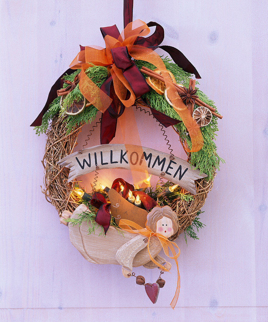 Door wreath made of gold-plated vine blanks with wooden angel, fairy lights