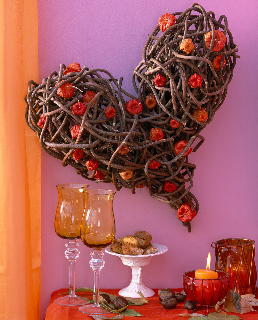 Heart of branches, physalis lanterns, castanea chestnuts, leaves, glasses, biscuits