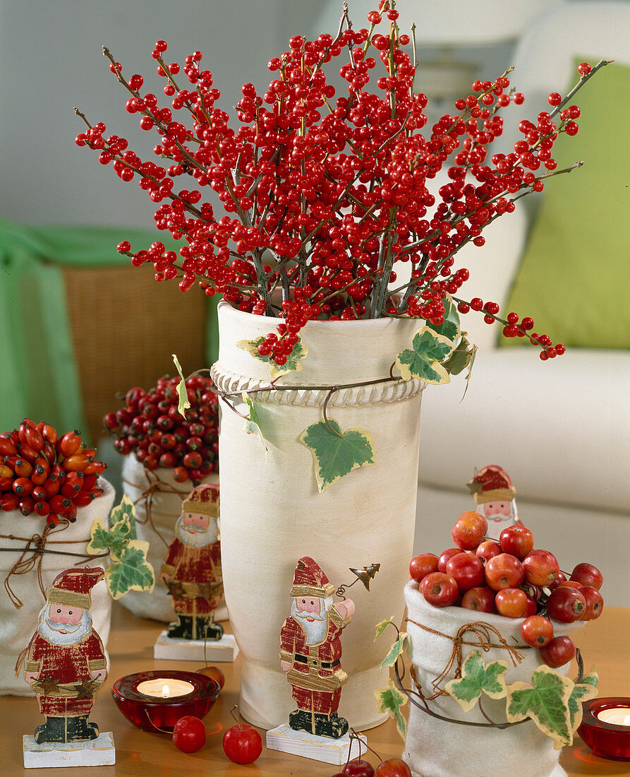 Bouquet of branches of holly, Malus (ornamental apple) and Rosa (rosehip)