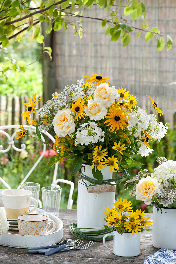 White-yellow bouquet in enamelled milk jug,