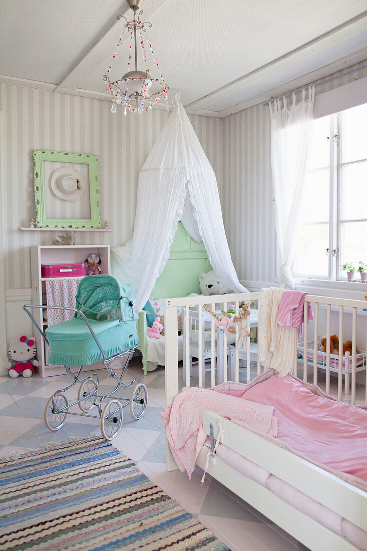 Vintage-style dolls' pram in charming nursery