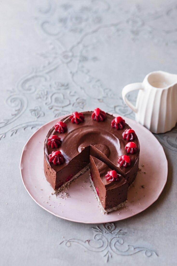 A vegan coconut and cranberry cake with chocolate cream