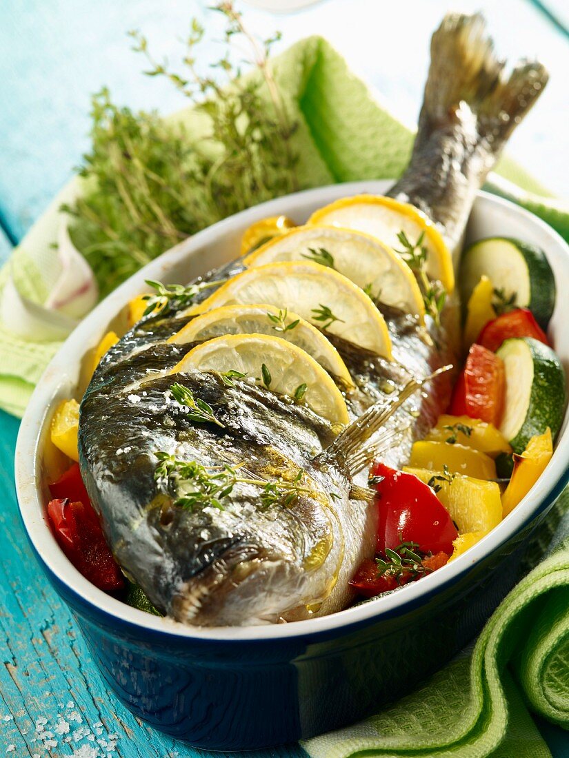 Whole sea bream on a bed of vegetables