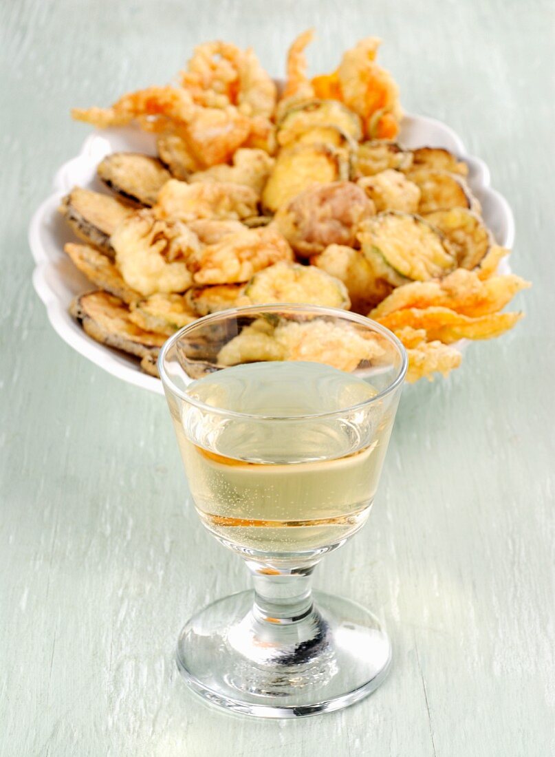 Fritto misto with vegetables and a glass of white wine