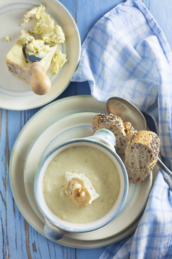 Celery and stilton soup in a bowl on a blue wooden table