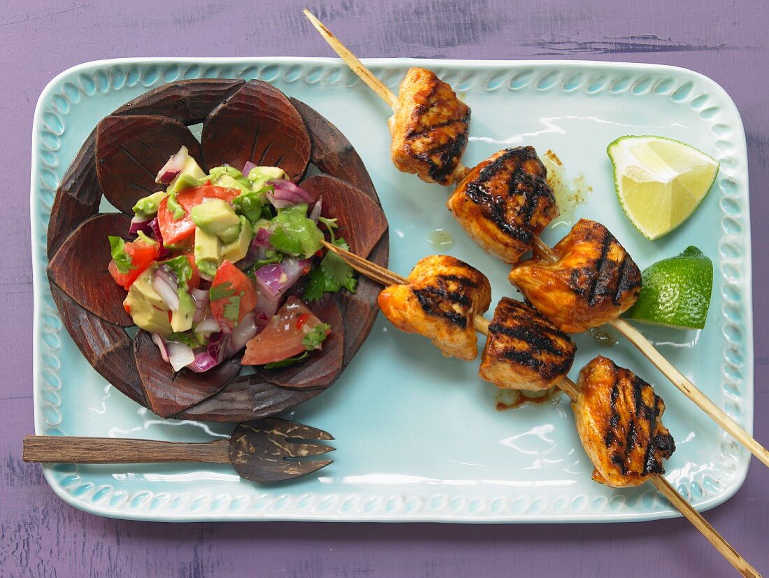 Tamarind chicken skewers with an avocado and tomato salad