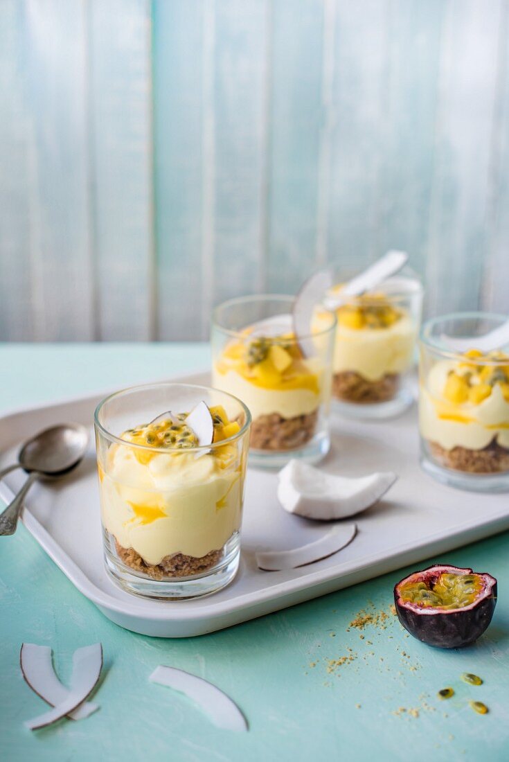 Individual mango and coconut cheesecakes wirh passion fruit