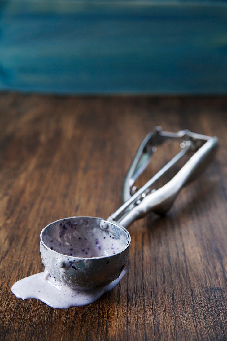 Ice cream scoop with melted ice cream in it