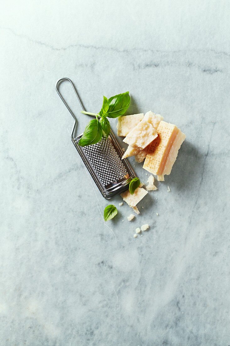 Parmesan with basil and cheese grater