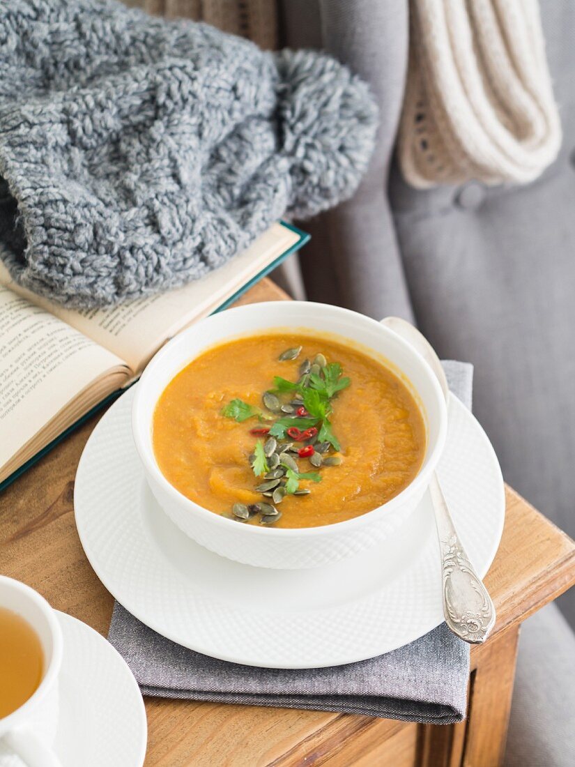 Winter cream of vegetables soup in a white bowl