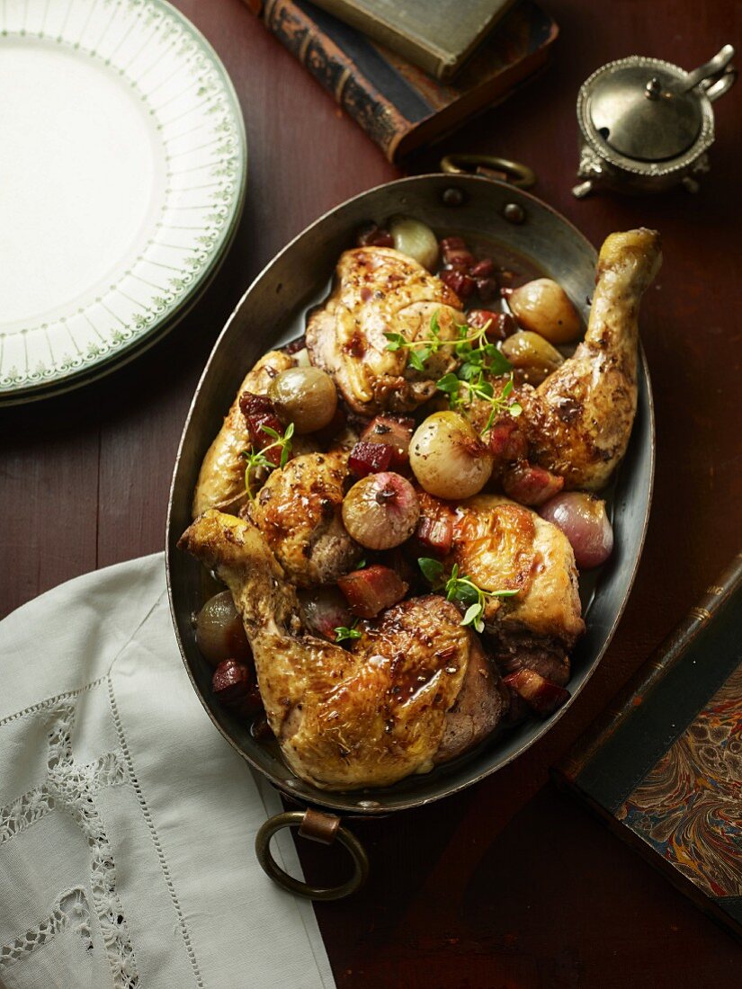 Coq au vin in a roasting tin