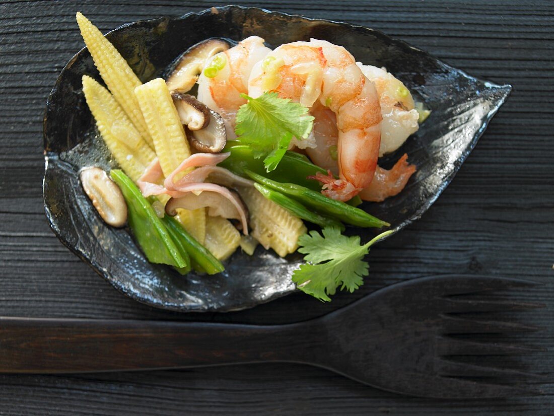 Prawns in an egg white coating with baby corn cobs, snow peas and shiitake mushrooms