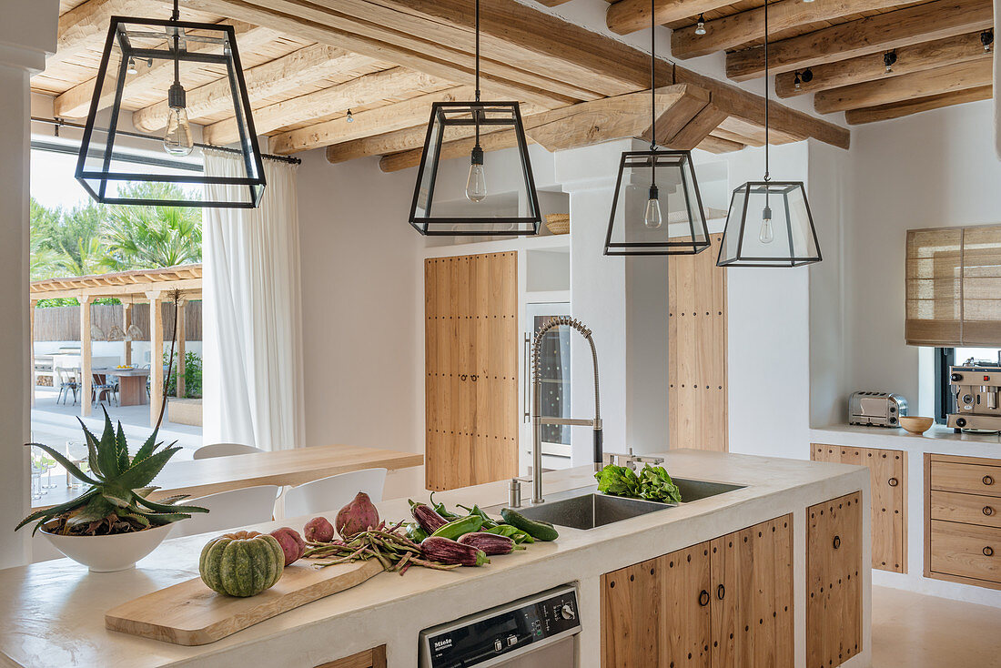 Lanterns above island counter in Mediterranean kitchen